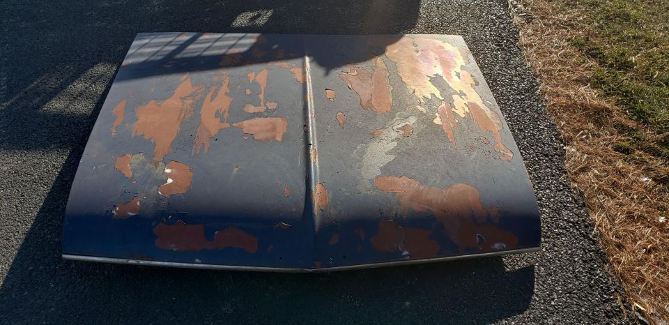 Hood with peeling paint and rust spots
