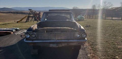 1962 Ford Galaxie - Front view of a 1962 Ford Galaxie with its hood open, sitting in a rural yard.