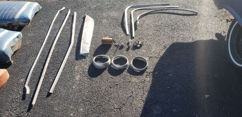 1962 Ford Galaxie - Various car parts, including trim and seat cushions, are spread out on the ground.