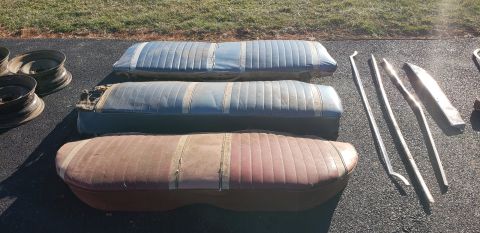 1962 Ford Galaxie - Car seats and trim pieces are laid out on asphalt, likely for sale or restoration.