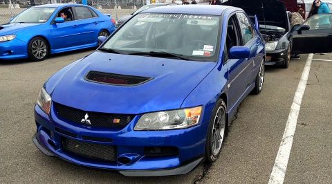 2006 Mitsubishi Evolution - A blue 2006 Mitsubishi Lancer Evolution VIII is parked at an event with other cars visible.