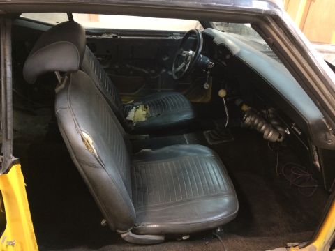 1969 Chevrolet Camaro - Interior view of a 1969 Chevrolet Camaro, worn seats and a manual transmission.