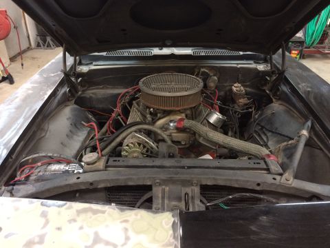 1969 Chevrolet Camaro - The engine bay of a 1969 Chevrolet Camaro, a V8 engine and aftermarket air cleaner, appears to be undergoing some work.