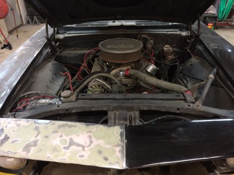 1969 Chevrolet Camaro - The engine bay of a 1969 Chevrolet Camaro shows its V8 engine and various components.