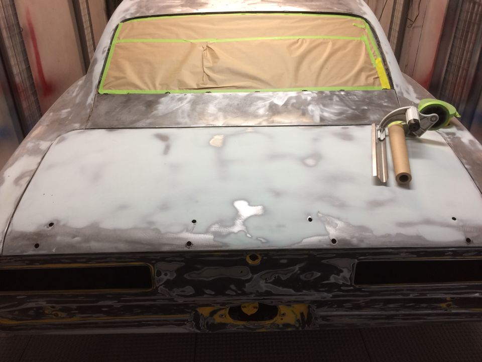 Car body in primer, rear view, masking tape on rear window