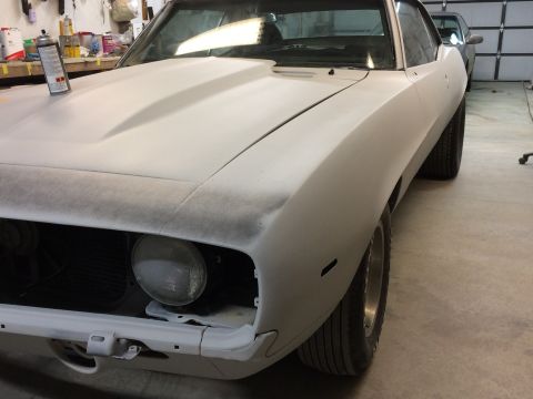 1969 Chevrolet Camaro - A 1969 Chevrolet Camaro is prepped for paint in a garage, with another car visible in the background.
