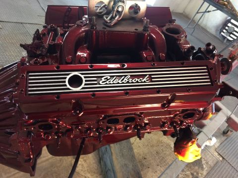 1969 Chevrolet Camaro - A freshly painted engine with an Edelbrock intake manifold is shown, ready for installation.