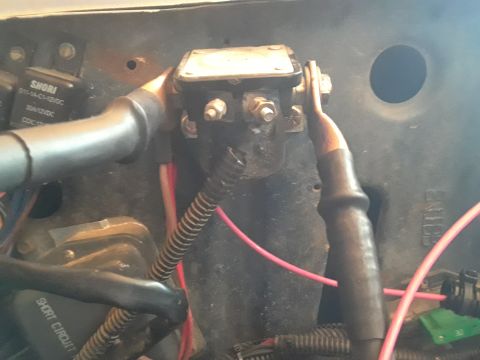 1985 Ford Bronco - Detail of automotive electrical components, including a relay and wiring, with visible part numbers and warnings.