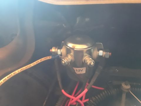 1985 Ford Bronco - Close-up of a 12V starter solenoid, part of a vehicle's electrical system.