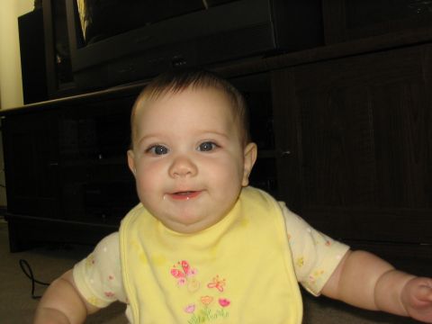 2004 Ford Taurus - A baby is wearing a yellow bib with butterflies and flowers.