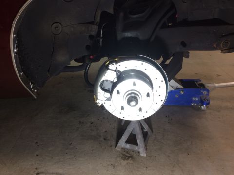 1969 Chevrolet Camaro - Front brake assembly on a car, showing a drilled rotor and caliper.