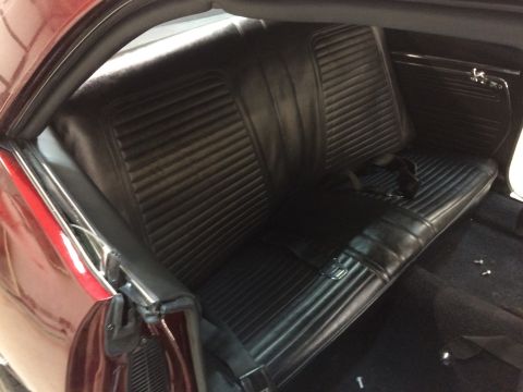 1969 Chevrolet Camaro - Rear interior view of a 1969 Chevrolet Camaro, black vinyl bench seats and seatbelts.
