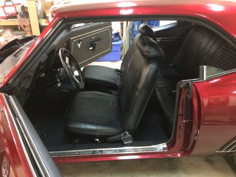 1969 Chevrolet Camaro - Interior view of a 1969 Chevrolet Camaro, black seats and door panels.