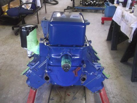 1967 Ford Galaxie - A freshly painted engine block sits on a stand in a workshop setting.