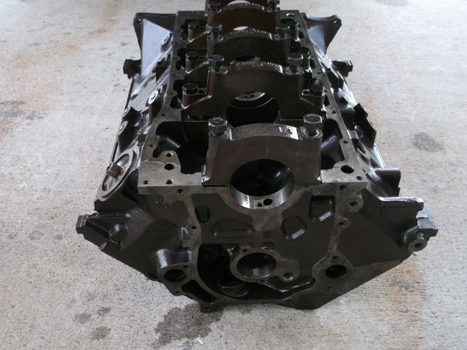Engine block on concrete floor. Supermotors.net logo visible