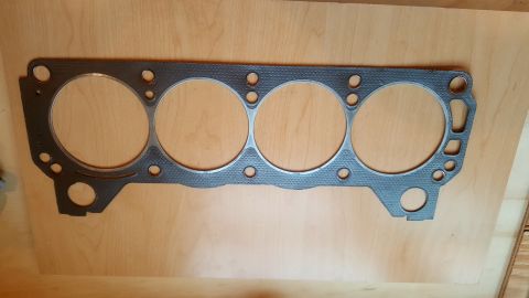 1973 Ford Mustang - Engine gasket shown flat on a wooden surface.