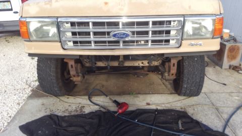 1990 Ford F-250 - Close-up of a Ford truck's front end, showing the grille, headlights, and 4x4 badging.