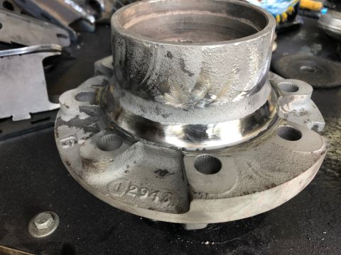 1992 Jeep Wrangler - Close-up of a metal wheel hub assembly, showing stamped part numbers and signs of wear.