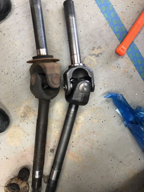 1992 Jeep Wrangler - Comparison of a used driveshaft with a new replacement, highlighting the condition of the U-joints and shafts.