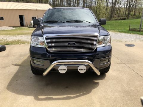 2005 Ford F-150 - Front view of a dark blue Ford F-150 pickup truck with a chrome grille and a bull bar.