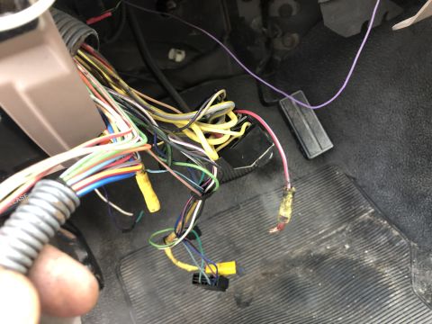 1995 Ford Bronco - Messy vehicle wiring harness visible inside the cabin, near the driver's footwell.