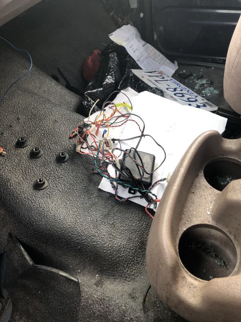 1995 Ford Bronco - A messy interior view shows a tangle of wires and a Virginia license plate on the floor of a vehicle.