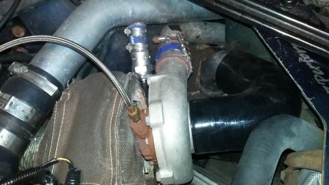 Turbocharger with braided oil line and blue-banded hose clamps