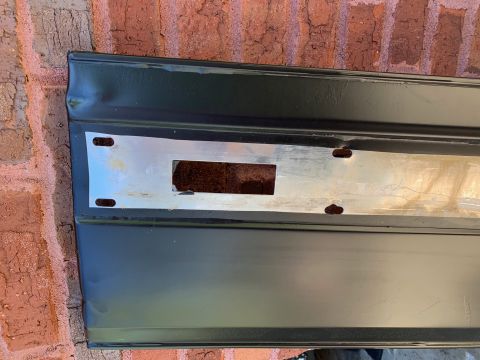 1994 Ford Bronco - Vehicle panel with cutout and mounting holes, possibly for a license plate or emblem.