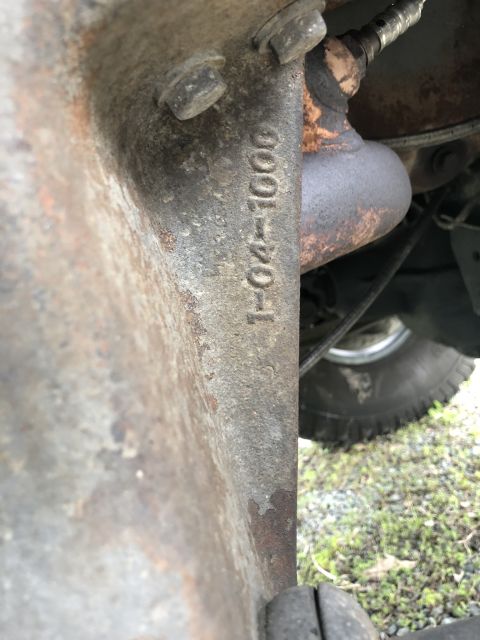 1995 Ford Bronco - A close-up view of a vehicle part shows stamped casting numbers and part of the exhaust system.