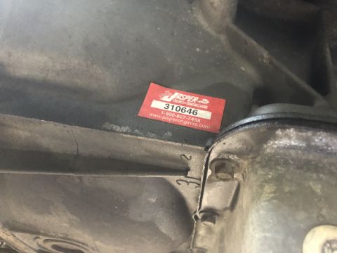 1995 Ford Bronco - A Jasper Engines & Transmissions sticker is affixed to the underside of a vehicle's component.
