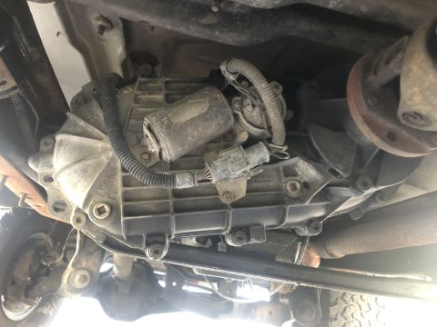 1995 Ford Bronco - Close-up of the vehicle's drivetrain components, showing the transmission and transfer case assembly.