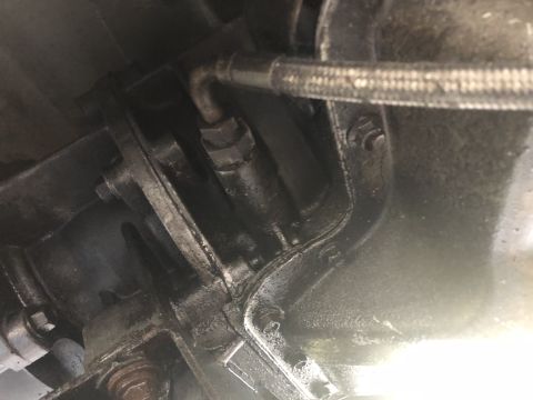 1995 Ford Bronco - Underside view of vehicle mechanical components, including transmission and brake lines.