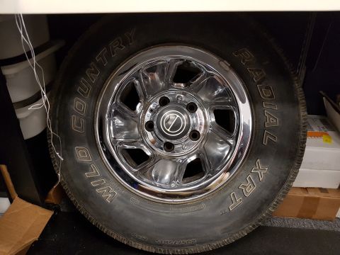 1978 Ford Bronco - A close-up of a tire and chrome rim with "Wild Country Radial XRT" text visible on the tire sidewall. The tire is mounted on a vehicle, lik…