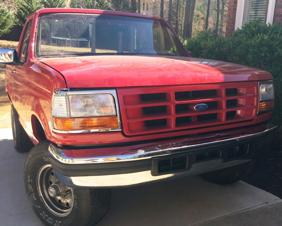 Red Ford pickup truck front view
