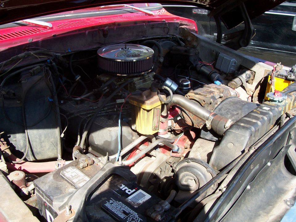 Engine bay with chrome air cleaner and yellow fluid reservoir