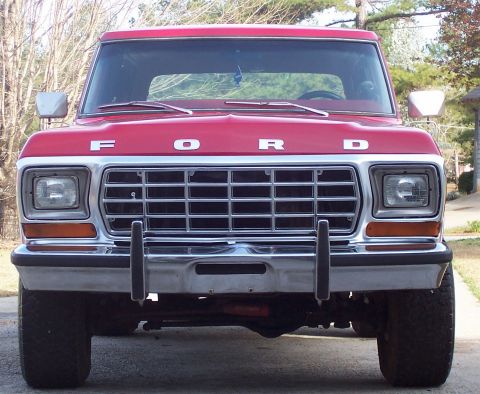 1979 Ford Bronco - This red Ford truck features a prominent chrome grille and 'FORD' badging on the hood.