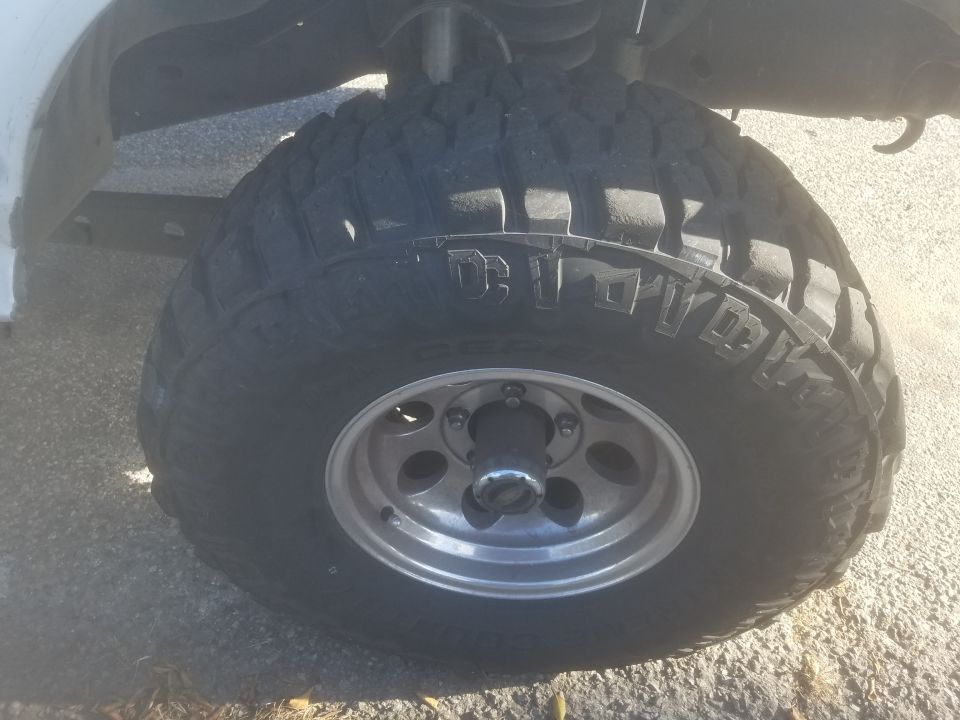 1992 Ford Bronco front passenger tire and wheel, all-terrain tire