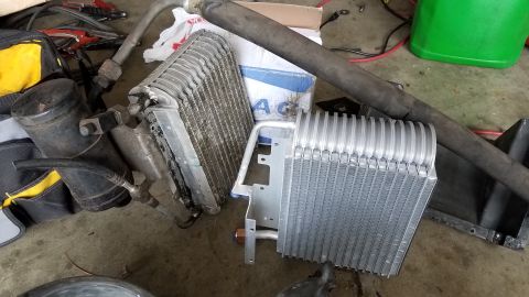 1985 Ford Bronco - Two air conditioning components, an evaporator and a receiver-drier, are shown in this image.