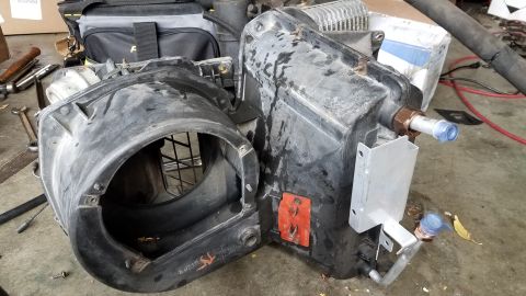 1985 Ford Bronco - This is a disassembled automotive air conditioning evaporator case, likely removed for repair or replacement.