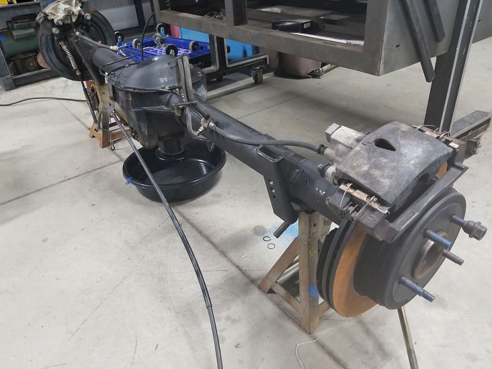 A lot has changed, and a lot of money has been spent, but not on anything that shows...

To put this in my '83 Bronco, I had to regear it.  I didn't want to spend the money on new Ford gears (~$350), and I certainly didn't want aftermarket gears, so I took a chance on a take-out set of Ford 3.08s (~$150 eBay), which of course required an install kit (~$40 RockAuto), new axle seals (~$15 RockAuto [url=https://www.amazon.com/dp/B0012UK41W]National/Timken 8835S[/url]), and a new pinion shaft lock bolt (~$5 Ford).  When I pulled the axles, I noticed a serious groove in the RH axle due to bearing wear.  Ford wants ~$250 for a new shaft, so I took another chance on a Dorman ($130 O'Reilly, made in India) which included a bearing (apparently made in USA by KOYO), a seal (no ID), lugs & nuts (no ID).  But I bought a MotorCraft bearing (~$30 eBay), and reused the original lug studs.  I paid a friend with a LOT of gear experience $150 to set up the gears, and I reassembled the axle.  The original oil was clean, and what little metal was in it settled out, so I poured it back in & E6000'ed the sandblasted & painted cover back on.  I'm tilting it back & forth to put oil into the wheel bearings before installation.  I'll figure out the e-brake cables after the axle is in the truck (which is why I'm doing it to my DD first).

Ford 8.8" axle uses 10 lug studs [url=https://www.tascaparts.com/oem-parts/ford-wheel-stud-d6az1107a]D6AZ-1107-A[/url] ('83-00)
Dana 44IFS uses 10 lug studs D6TZ-1107-A ('83-96)
Ford TIB axle uses 10 lug studs F4UZ-1107-A ('94-96)

If I do this swap to the '93EB I'm building, I won't have to regear it (3.55 already).  And if I find one with good bearings, I won't have to spend all that money again, either.

I pressure-washed & reused the [url=https://www.amazon.com/dp/B000NTVLL0]pads (4C2Z-2001-BB)[/url] & [url=https://www.tascaparts.com/oem-parts/ford-brake-shoes-4c2z2648aa]e-brake shoes (4C2Z-2001-BB)[/url]

I haven't decided yet whether to replace or reuse the U-bolts...
