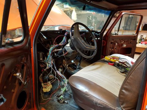 1978 Ford Bronco - The vehicle's interior is disassembled, showing extensive wiring and components.