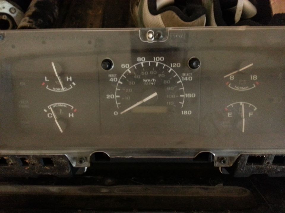 Dashboard instrument cluster with speedometer, fuel gauge, temperature gauge, and oil pressure gauge