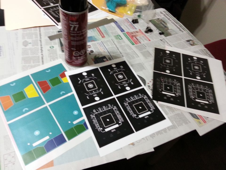 Spray can and printed sheets with colorful shapes and black and white diagrams
