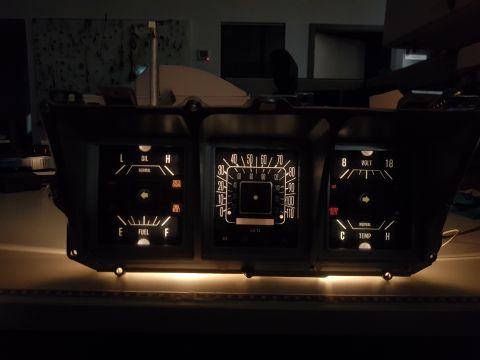 1978 Ford Bronco - Instrument cluster from a 1978 Ford Bronco, illuminated gauges for fuel, oil, voltage, and temperature.