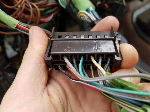 1978 Ford Bronco - Close-up of a vehicle's wiring harness connector with numbered pins and wires.