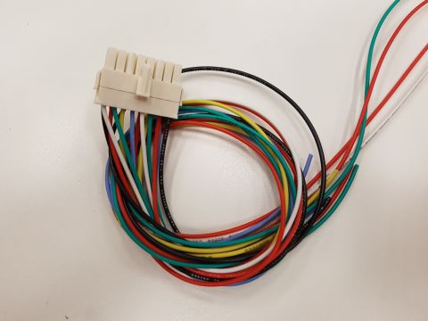 1978 Ford Bronco - A close-up view of a multi-colored wiring harness with a white connector.
