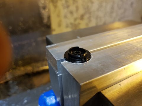 1978 Ford Bronco - A black plastic component is secured to a metal fixture, possibly during a repair or fabrication process.