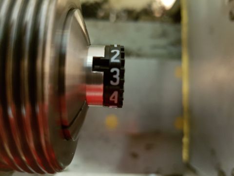 1978 Ford Bronco - A close-up view of a mechanical part a dial with visible numbers 2, 3, and 4.