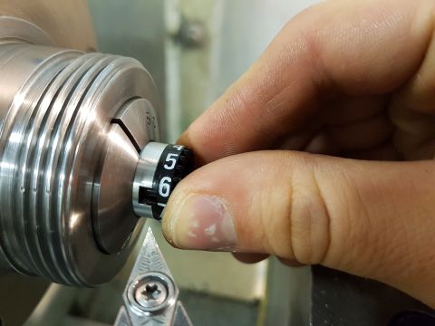 1978 Ford Bronco - Close-up of a hand adjusting a numbered dial on industrial machinery.