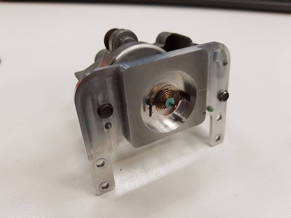 Close-up of a mechanical component with a visible spring mechanism